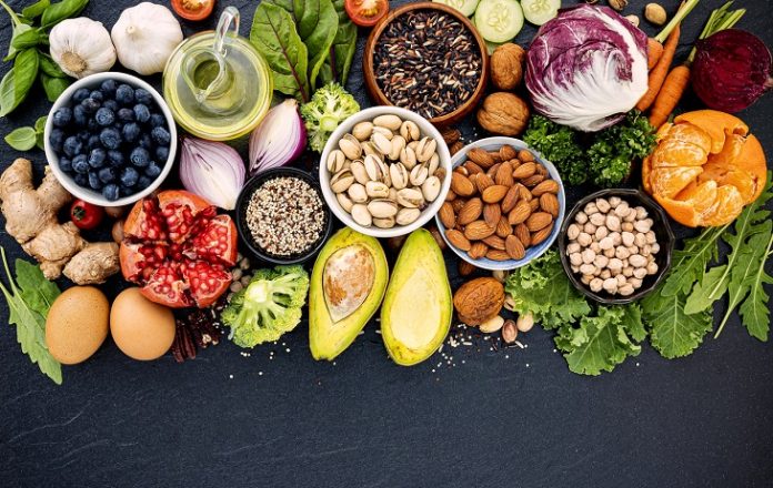 Ingredients for the healthy foods selection. The concept of healthy food set up on dark stone background.